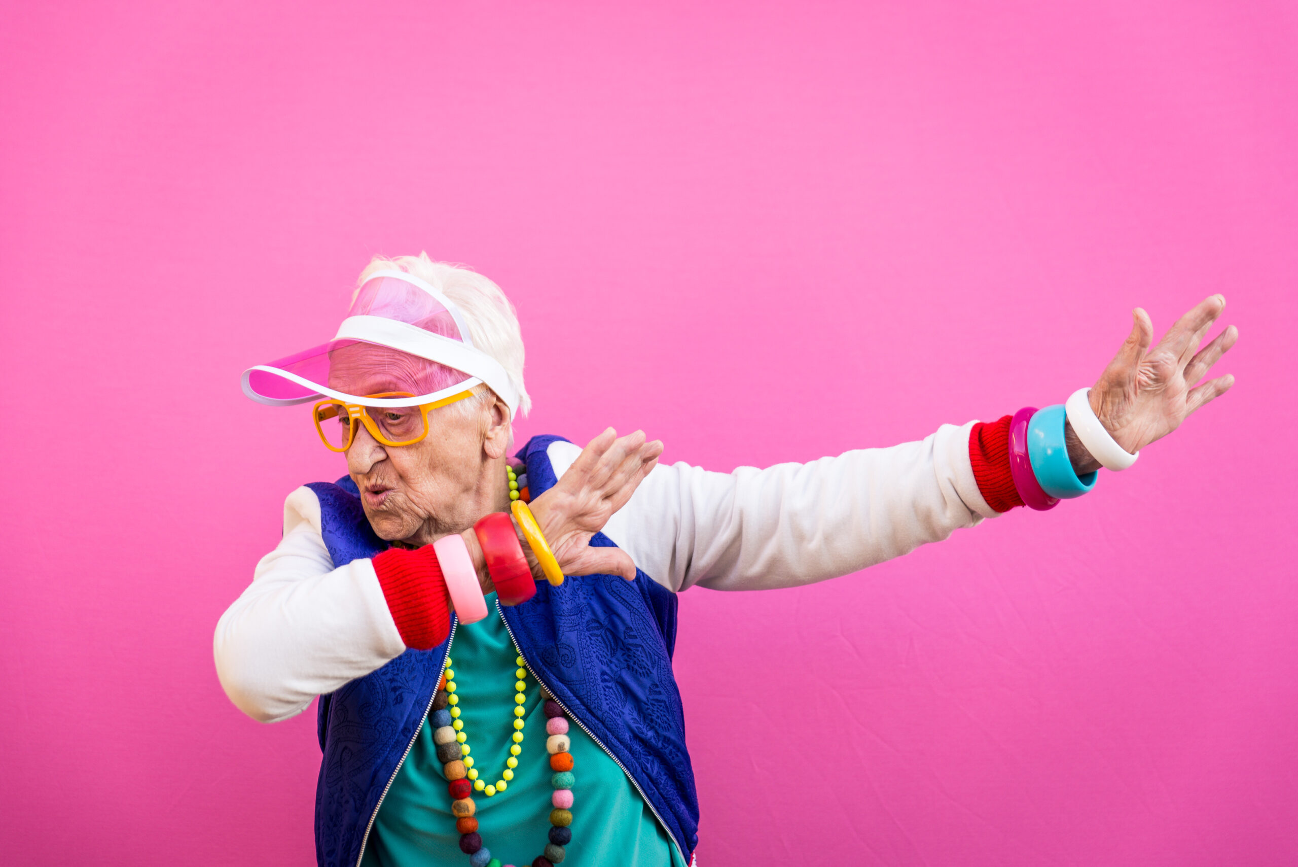 Funny grandmother portraits. 80s style outfit. Dab dance on colored backgrounds. Concept about seniority and old people